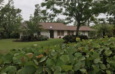 Beautifully landscaped ranch with pool on 1.3 acres near ocean.