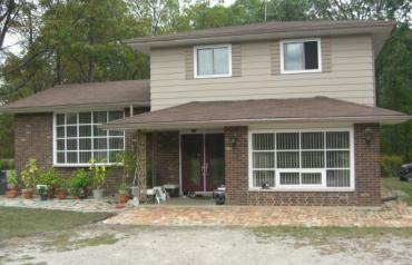 Gorgeous country home in Pleasant Valley,4.8 acres mature treed lot with bridge, gazebo and creek.